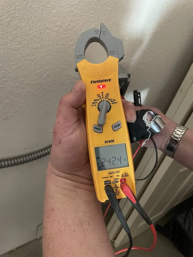 Voltage testing with clamp meter during Whole House Surge Protector in Camden
